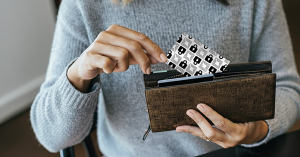 Wallet Defender card sliding into a wallet — credit-card sized RFID protection