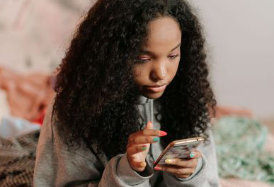 College student operating a smart phone.