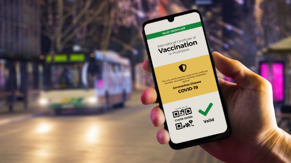 Smartphone displaying a valid digital vaccination certificate for COVID-19 in male's hand-Vaccine Passports